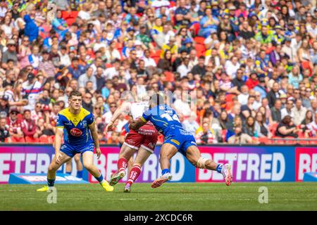 The 2024 Betfred Challenge Cup Final. Rodrick Tai grabs hold of Liam Marshall with Josh Thewlis ready to assist Stock Photo