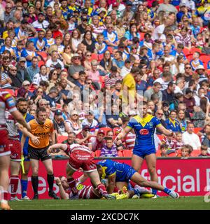 The 2024 Betfred Challenge Cup Final. Rodrick Tai is brought to the ground by Jake Wardle and Harry Smith as Danny Walker looks on Stock Photo