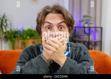 Oh my God Wow. Excited amazed overjoyed young man surprised looking at camera with big eyes shocked by sudden victory good win news celebrating success triumph. Portrait of happy guy at home room Stock Photo