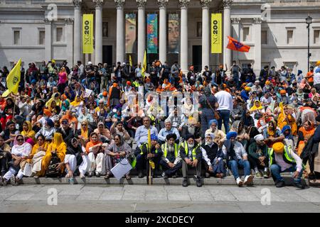 London, UK, 16th June 2024. British Sikhs sit on the steps in Trafalgar Square awaiting the start of a rally to commemorate the 40th anniversary of the Amritsar Golden Temple massacre. Credit: James Willoughby/Alamy Live News Stock Photo