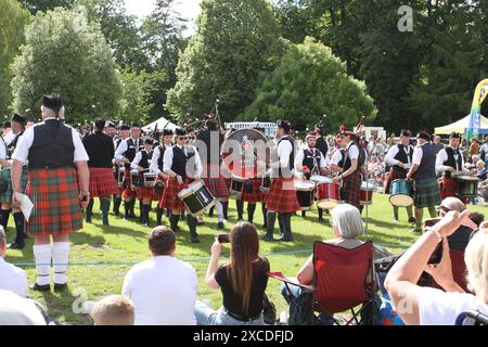 Colchester, UK. 16th Jun 2024. Pipes and drums from across the south of England come together in the Lower Castle Park, Colchester. Medleys of Scottish tunes are being performed together with displays of Highland Dancing. First organised in 1994 the event provides a local contest for pipe bands. Credit: Eastern Views/Alamy Live News Stock Photo