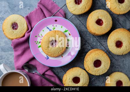 Tea and jam bscuits on pink plate Stock Photo