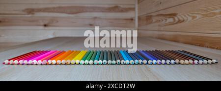 Set of coloured pencils arranged in a rainbow colour pattern Stock Photo