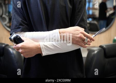 Closeup view of experienced barber working in hairdressing salon Stock Photo