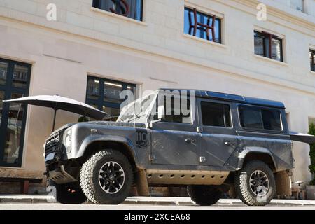 Bucharest, Romania - June 16, 2024: Land Rover Defender 110 black 4x4 car parked on street side in center of the city Stock Photo