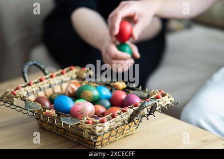 easter egg tapping, mother and son egg tapping next to basket with easter eggs, selective focus, close up of hands egg tapping Stock Photo