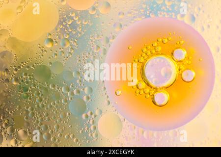 Close-up of oil and water bubbles creating a colorful and abstract pattern. vibrant hues and intricate details offer a captivating visual experience. Stock Photo