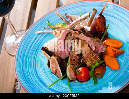 Roasted mutton ribs with figs, vegetables, demi-glace and red wine Stock Photo