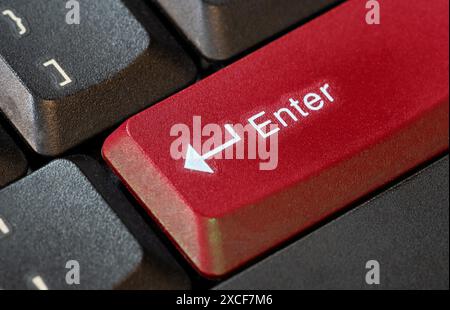 Large bright red colored enter key on a computer keyboard, confirmation call to action abstract concept, object closeup macro detail, nobody. Acceptin Stock Photo