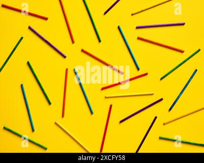 Abstract geometric yellow background with colorful cylinder stick shapes. Modern minimalistic template design for poster, cover, branding, banner or p Stock Photo