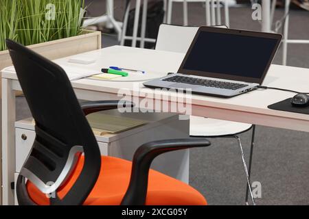 Office interior with laptop and desktop. Contemporary place of work Stock Photo