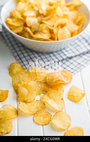 Crispy Potato Chips on a white table. Stock Photo