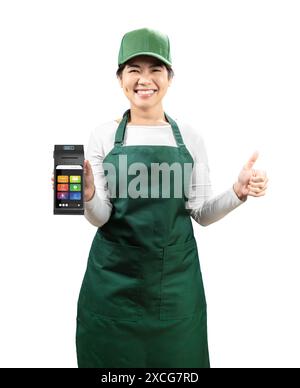 Asian seller wear green apron and green cap smiling with hand holding card reader thumb up isolated on white Stock Photo