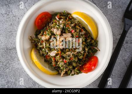 Healthy salad with capers, quinoa and walnuts on stone table Stock Photo