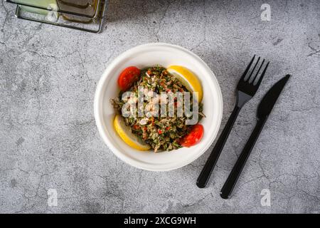 Healthy salad with capers, quinoa and walnuts on stone table Stock Photo