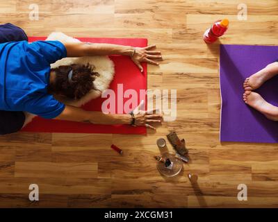 Two Yogis In Child's Pose With A Marijuana Pipe Nearby Stock Photo