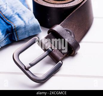 male jeans and leather belt on wooden background Stock Photo