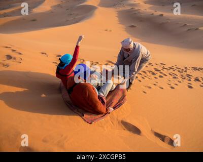 Tourists enjoying on desert in Erg Chebbi, Morocco Stock Photo