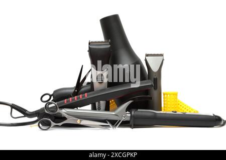 Hairdresser's accessories scissors, curling iron, hair clipper and hair dryer on white background. Professional hairdresser tools Stock Photo