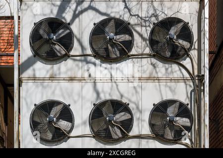 Condenser unit or compressor on rooftop of industrial building, HVAC equipment: Heating, Ventilating, Air Conditioning system. Low angle view. Stock Photo