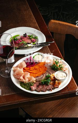 various cuts of meat on a plate. a meat plate. meat appetizer Stock Photo