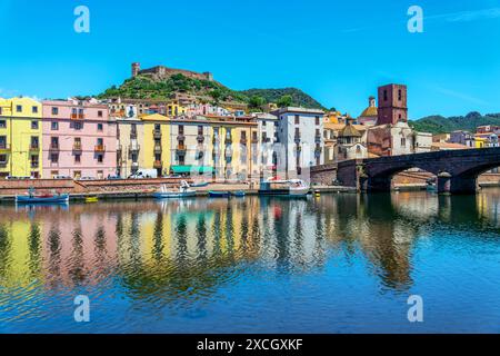 View of the old town of Bosa, colorful houses reflecting in the Temo river, the bridge and the castle, SSardinia island, Italy Stock Photo