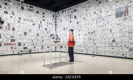 London, UK. 17th June, 2024. Staff with 'The Encyclopedia of Invisibility', 2024-2018 (leather, guilding archival paper) and 'Six Thousand Years, 2018, (2078 room filling panels), which makes use of the huge spaces at the Hayward. ‘Tavares Strachan: There Is Light Somewhere' will be on show at the Hayward Gallery 18 Jun -? 1 Sep and shows a cross section of the artist's work throughout his career. Credit: Imageplotter/Alamy Live News Stock Photo