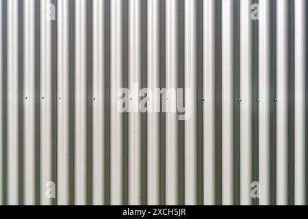 Corrugated metallic cover sheets, attatched with bolts to an industrial container for protection. Background use. Stock Photo