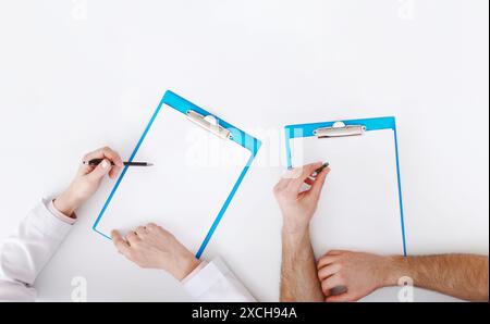 Medical Education. Doctors Writing On Clipboards At Seminar Stock Photo