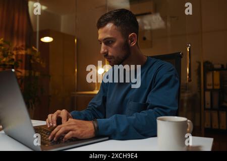 Portrait of serious coding developer working on laptop in office Stock Photo
