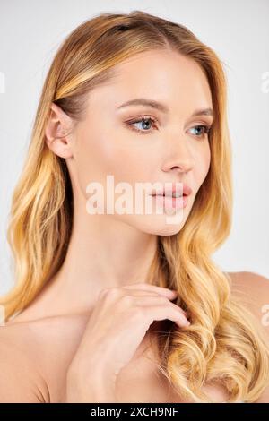 Woman with long blonde hair striking a pose. Stock Photo