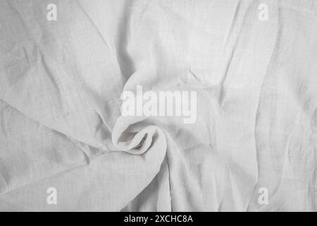 Wrinkled white canvas white cloth with a swirl, empty abstract backdrop for product placement Stock Photo