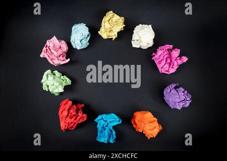 Colorful Crumpled Papers Circular Pattern on black background  copy space with  Paper Balls Arranged Stock Photo