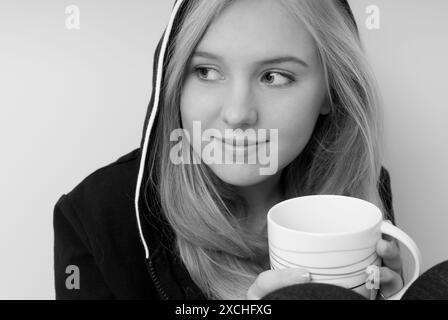 Caucasian teen girl holding coffee cup. USA Stock Photo