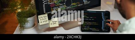 Web banner with programming code on screen of laptop and computer Stock Photo