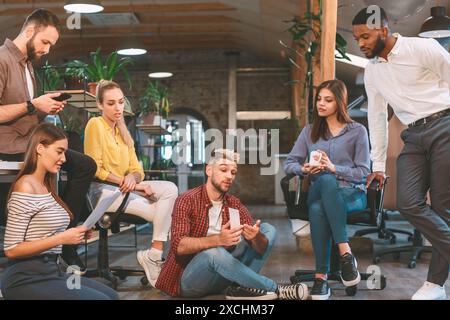 Young Professionals Engaged In A Casual Office Meeting Late Morning Stock Photo
