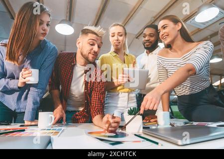 Creative Team Collaborates on Design Project in Modern Office During Daytime Stock Photo
