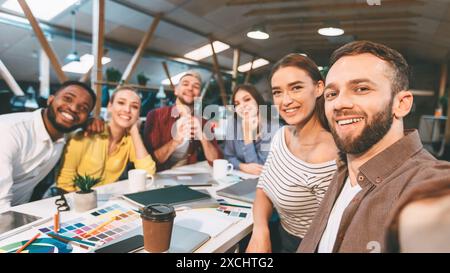 Happy designers making selfie at workplace, working on project Stock Photo