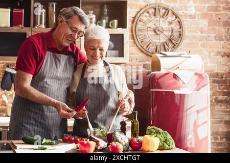Senior Couple Having Fun While Cooking in the Kitchen Stock Photo