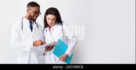 Two doctors in white coats discussing diagnosis Stock Photo