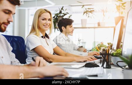 Group of People Working on Computers at Desk Stock Photo