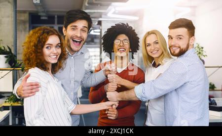Cheerful Team Celebrating Success in Modern Office Environment During Daytime Stock Photo