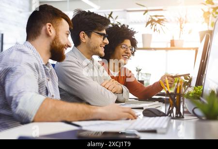 Group of People Sitting Around a Computer, Have Conversation Stock Photo