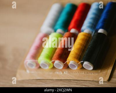 Multicolored sewing threads on paper bobbins and spools in blister packs. Threads for needlework, hobbies and recreation. Necessary item for every fam Stock Photo