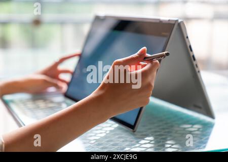 Female freelance developer coding and programming. Coding on two with screens with code language and application. Stock Photo