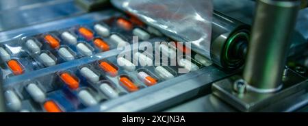 Capsule medicine pills during production line and packing process on modern pharmaceutical factory, Medical Drug Manufacturing. Stock Photo