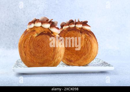 Supreme croissants with chocolate chips and cream on grey background, closeup. Tasty puff pastry Stock Photo