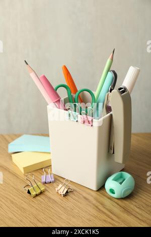 Stapler, holder and other different stationery on wooden table Stock Photo