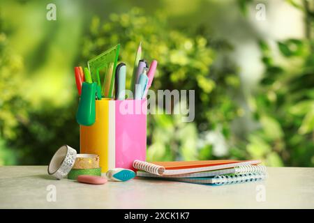 Stapler, notebooks, holder and other different stationery on white table Stock Photo