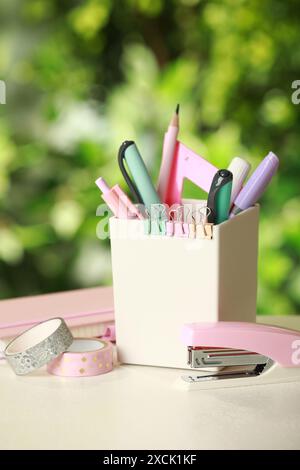 Stapler, holder and other different stationery on white table Stock Photo